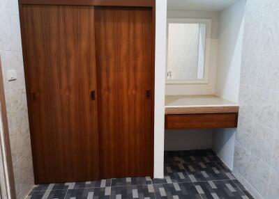 Bedroom with wooden wardrobe and built-in vanity