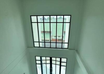 High-ceiling living room with large windows