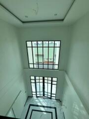 High-ceiling living room with large windows