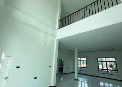 Spacious main living area with high ceiling and mezzanine