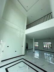 Spacious main living area with high ceiling and mezzanine