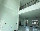 Spacious main living area with high ceiling and mezzanine