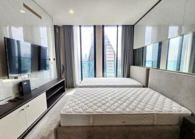 Modern bedroom with two beds and a TV