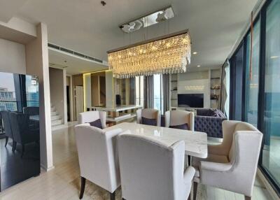 Modern living and dining area with chandelier