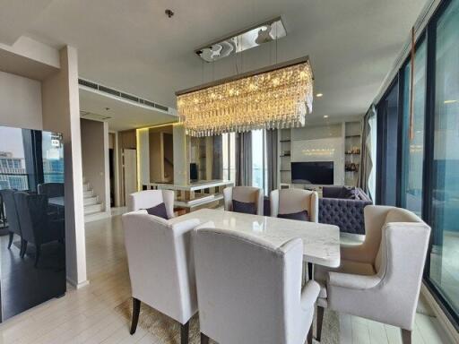 Modern living and dining area with chandelier