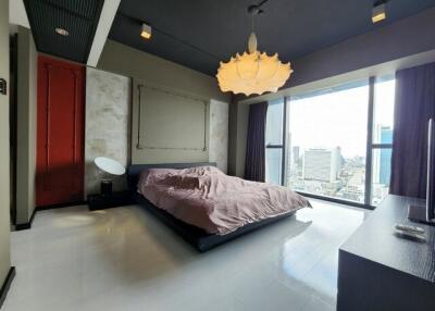 Spacious bedroom with a large window and city view