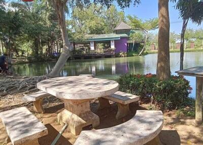 Scenic outdoor sitting area by a pond