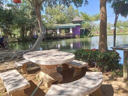 Scenic outdoor sitting area by a pond