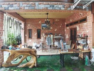 Open living area with rustic brick walls and wooden furnishings