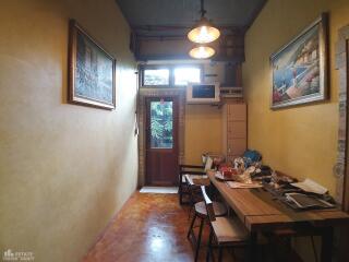 Narrow dining room with wall art and a wooden table