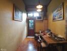 Narrow dining room with wall art and a wooden table