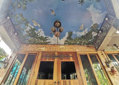 Outdoor area with artistic ceiling and wooden doors