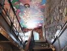 Staircase with comic-themed ceiling and vintage decor