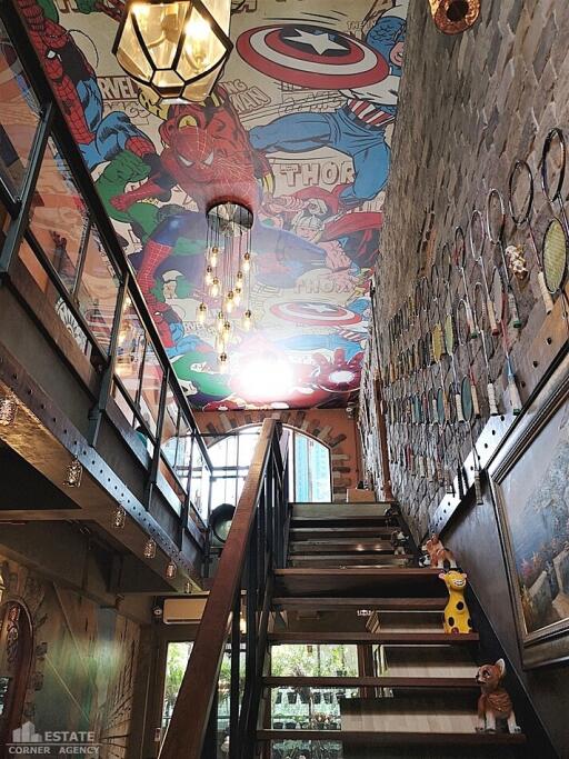 Staircase with comic-themed ceiling and vintage decor