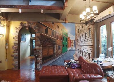 Living room with mural and vintage furniture