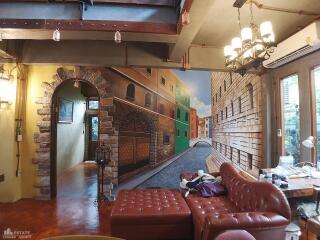 Living room with mural and vintage furniture