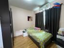 Cozy bedroom with wooden flooring, a single bed, and a wall-mounted air conditioner