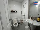 Modern bathroom with white tiles, a hanging shelf, and essential fixtures