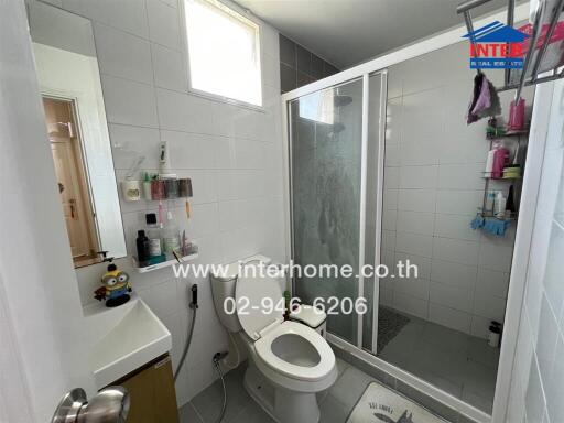 Modern bathroom with glass shower and white tiles