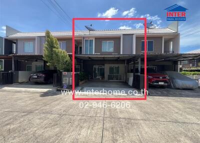 Modern townhouse with carport and driveway