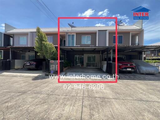 Modern townhouse with carport and driveway