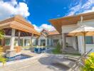 Exterior view of a modern house with a pool and seating area