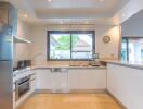 Modern kitchen with appliances and large window