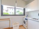 Laundry room with sink, washing machine and a window.