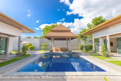 Beautiful backyard with a pool and outdoor seating area under a pavilion