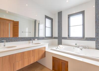 Modern bathroom with double sink and bathtub