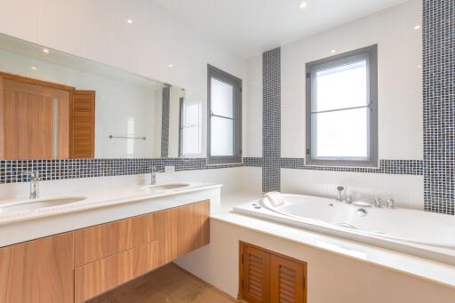 Modern bathroom with double sink and bathtub