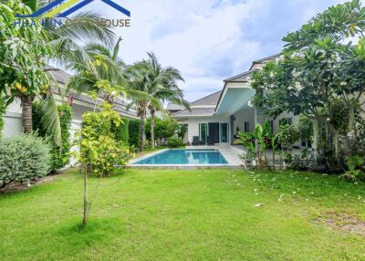 Beautiful single-story house with a swimming pool and lush garden