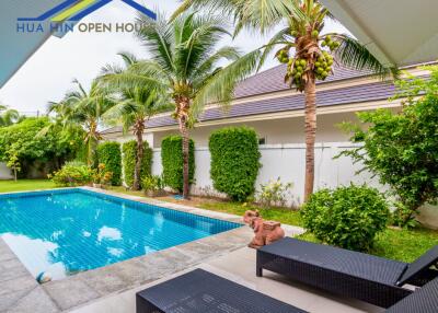 Outdoor area with swimming pool and lounge chairs