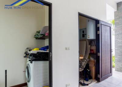 Laundry room with washer and storage space