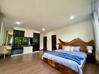 Spacious and modern bedroom with wooden accents and large mirrored closet