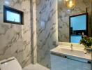 Modern bathroom with marble walls and contemporary fixtures