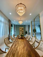 Dining room with large wooden table and modern chandeliers