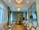 Dining room with large wooden table and modern chandeliers