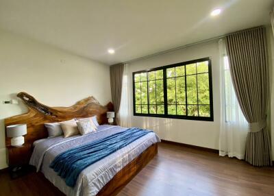 Spacious bedroom with large window and natural light