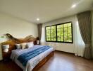 Spacious bedroom with large window and natural light