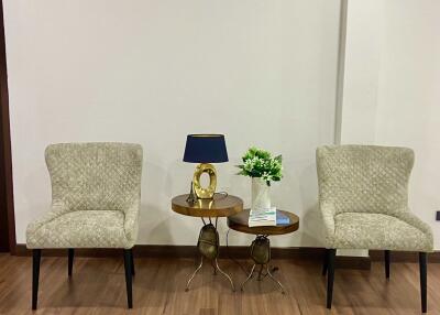 Cozy seating area with two upholstered chairs and a side table