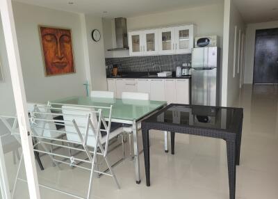 Modern kitchen and dining area with artwork and appliances