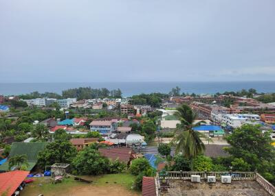 Aerial view of a coastal town with multiple buildings and greenery