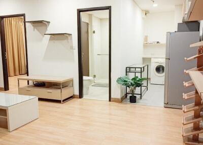 Main living area with a view into laundry and bathroom