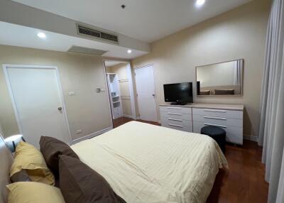 Modern bedroom with furniture and TV