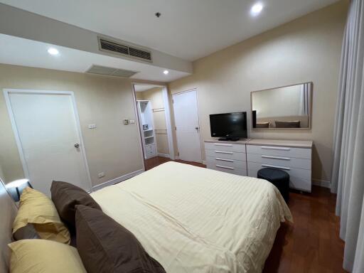 Modern bedroom with furniture and TV