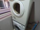 Stacked washer and dryer units in laundry area