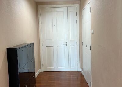 Hallway with wooden flooring and a shoe cabinet