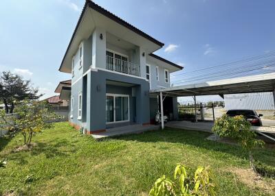 Front exterior view of a modern two-story house with a garden