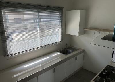 Modern kitchen with window and blinds